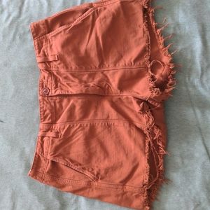 Distressed burnt orange shorts from Anthropologie